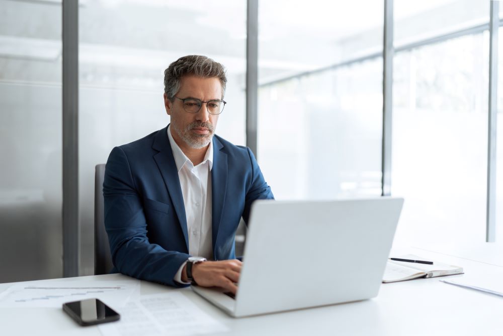 Businessmen working on his laptop in his office
