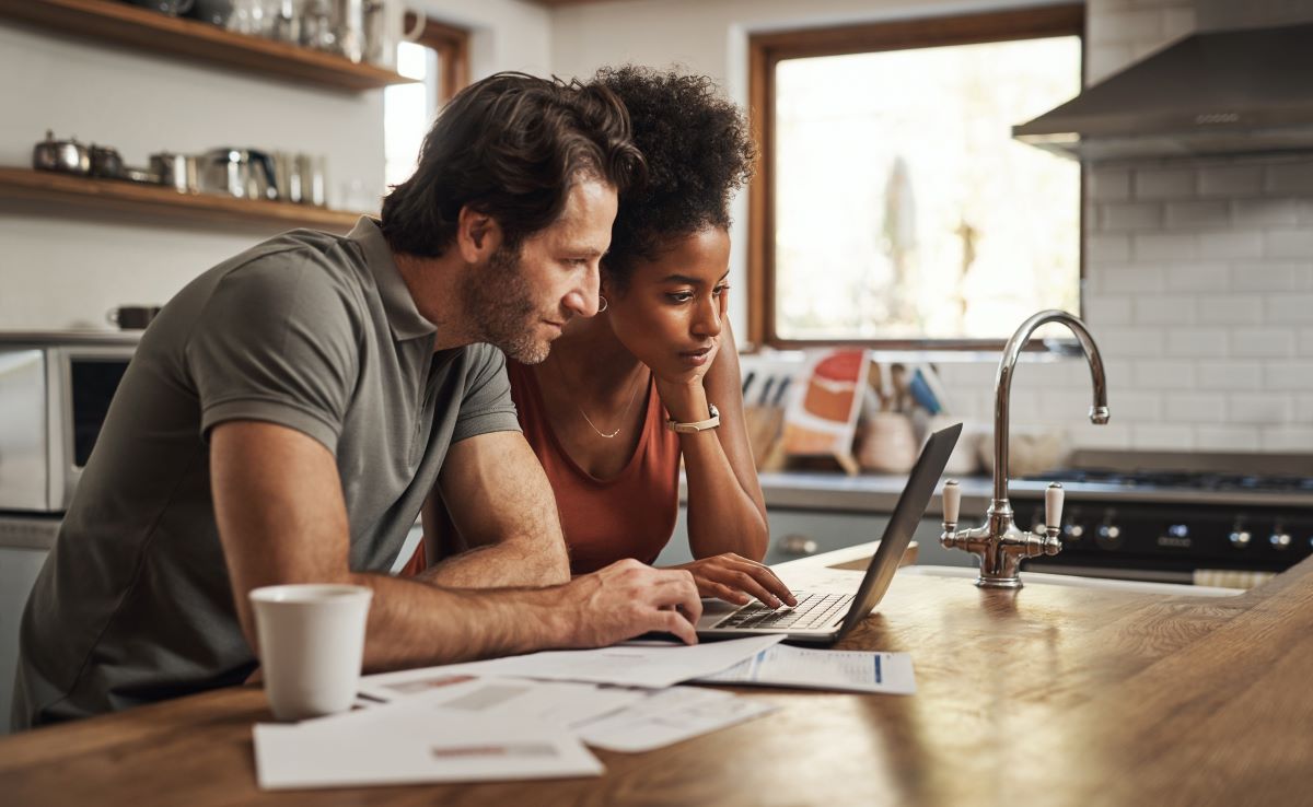 Couple reviewing something on a laptop